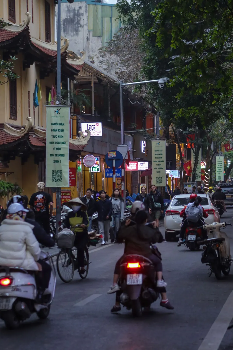 Motorbikes passing through a street in Hanoi